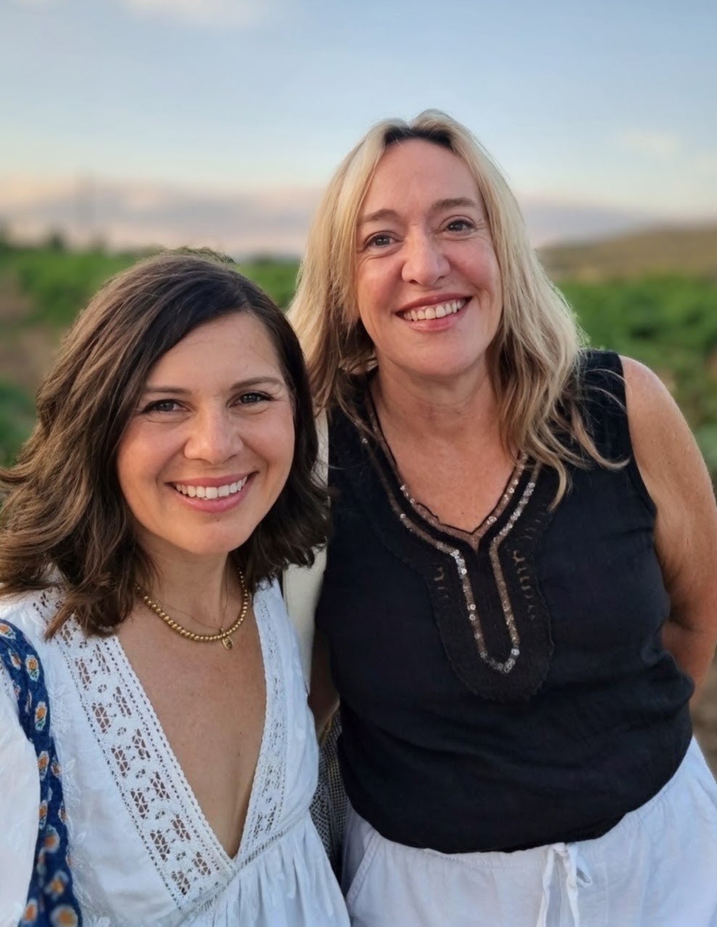 Stephanie and Amy smiling together outdoors among Var vineyards in Provence
